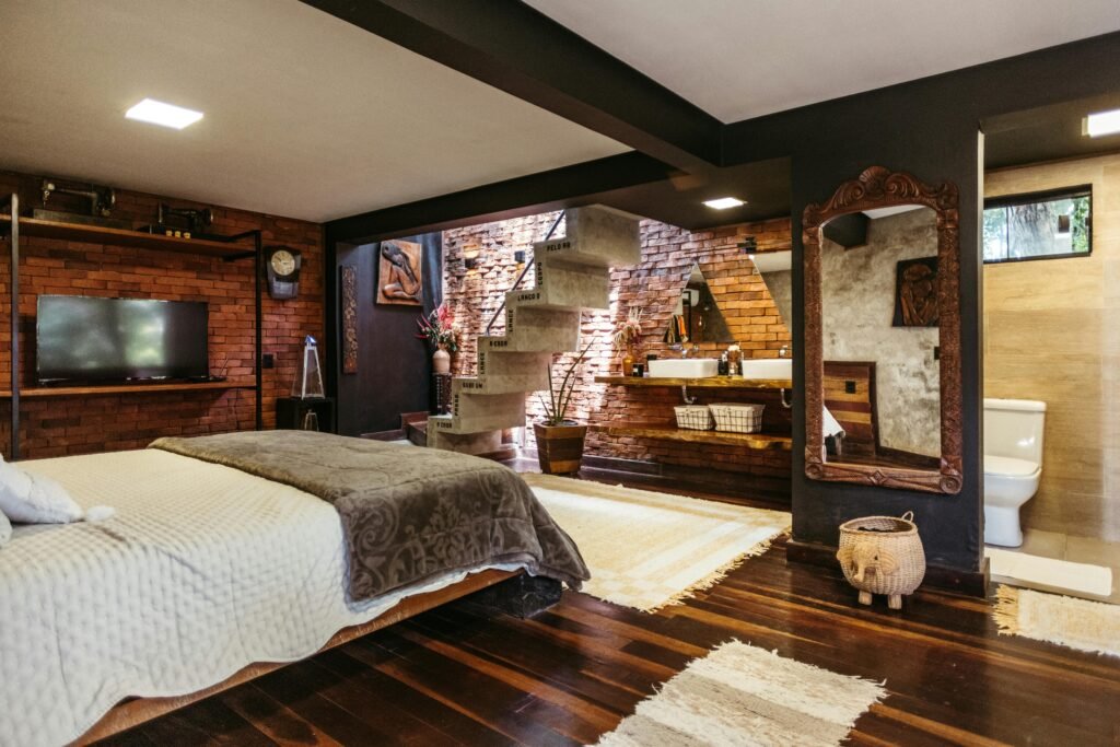 pexels-photo-30767897-30767897-1 Cozy bedroom featuring exposed brick walls, wooden accents, and a stylish rustic design.